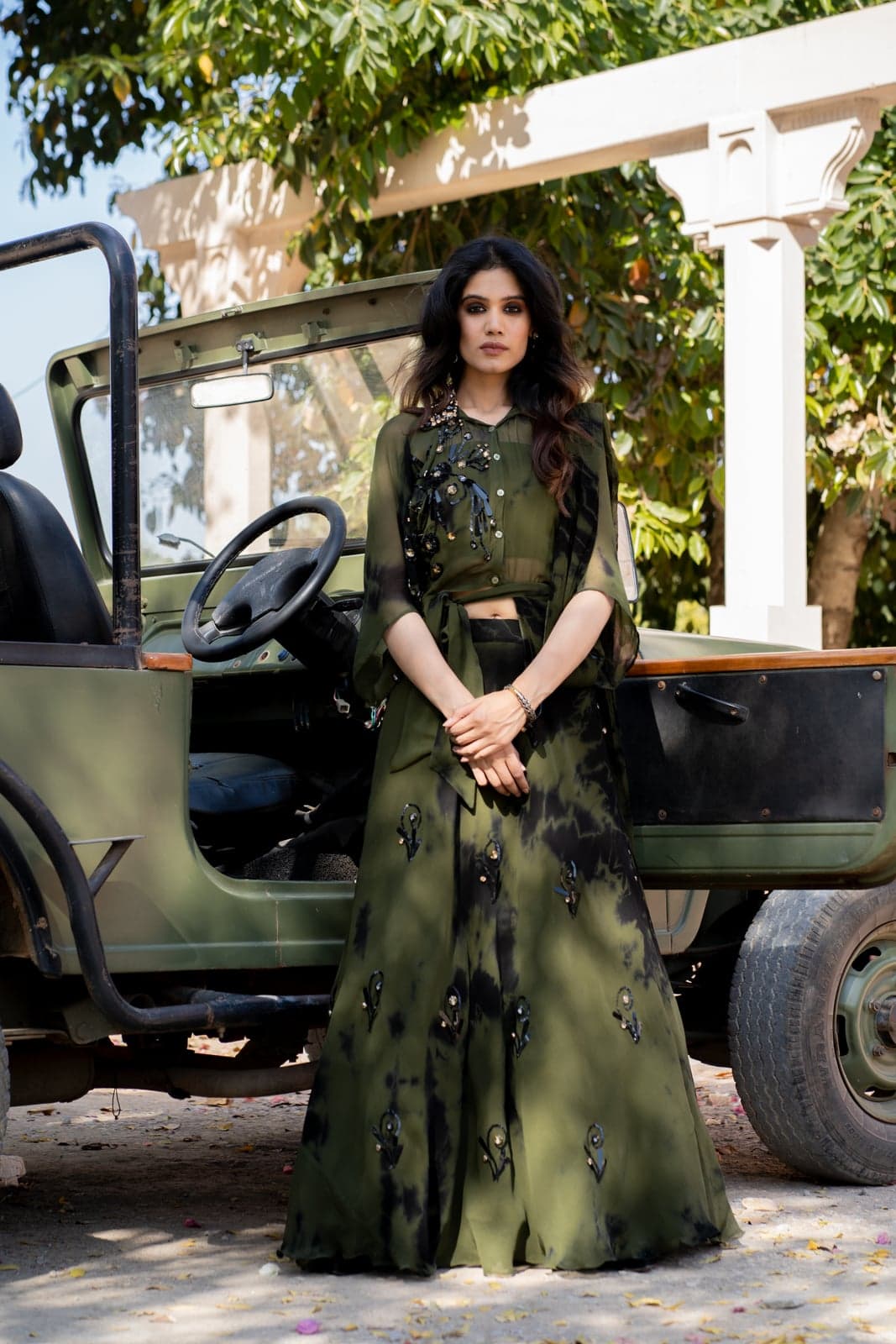 Olive green tie-dye sharara — close detail against the door of a vintage Jeep, three-dimensional sequin embroidery at the yoke.
