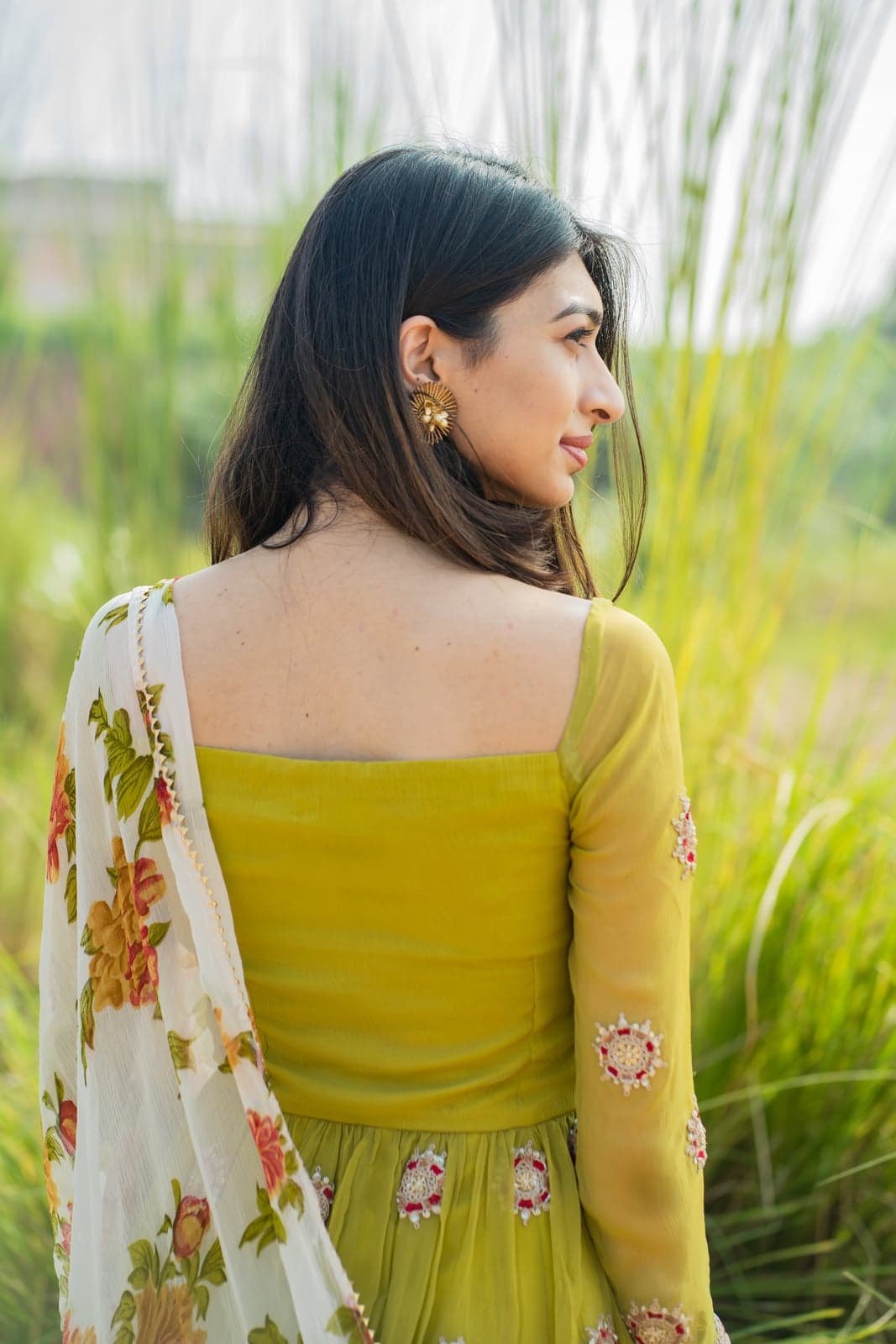 Lime green peplum bodice — close detail of the back yoke and embroidered sleeve, pampas backdrop.