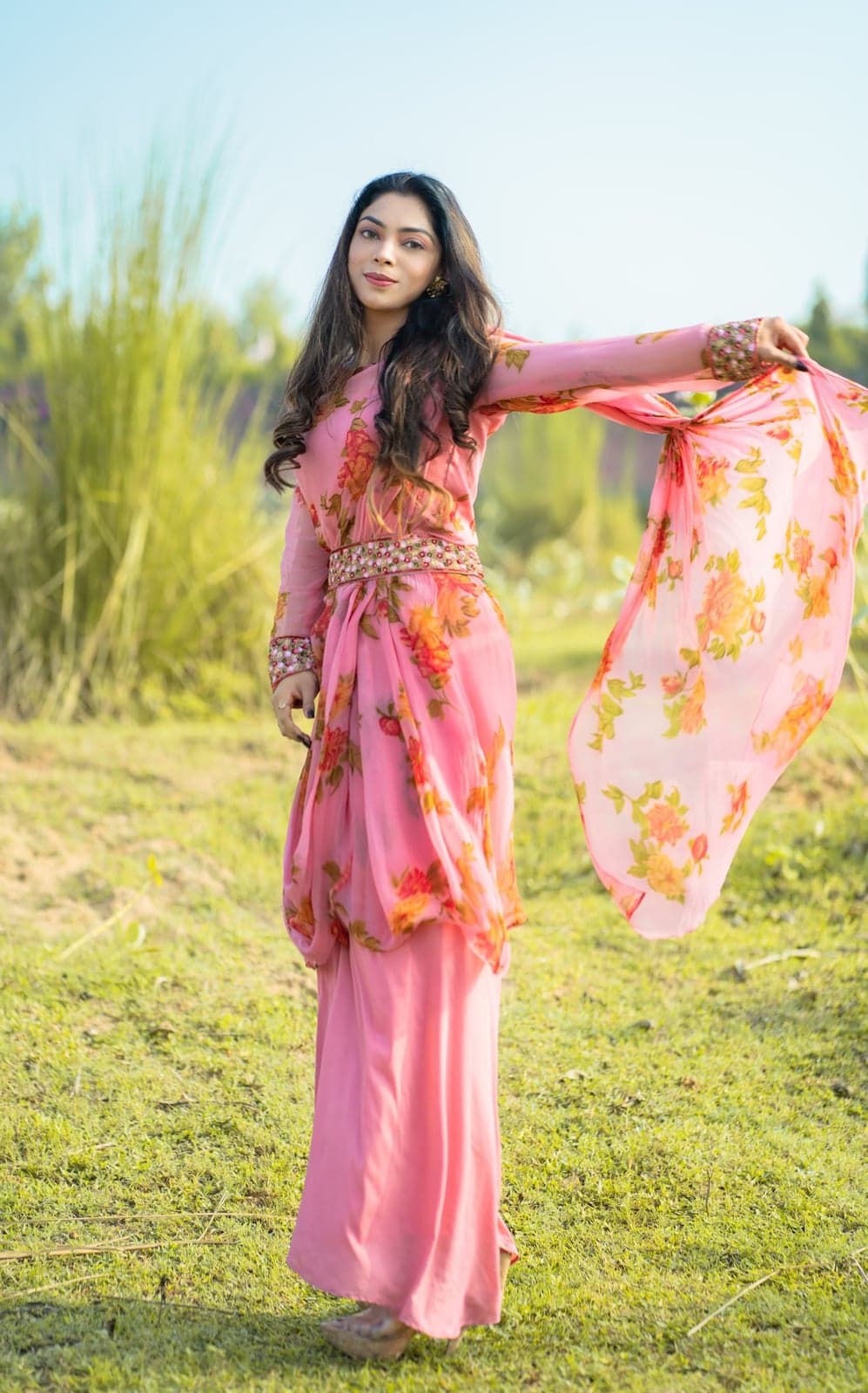 Pink chiffon palazzo set with rose-print dupatta — full-length twirl with the embellished waistband in detail.