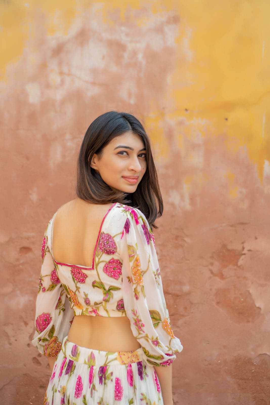 Ivory and pink rose-print maxi — twirl with the skirt opened out in afternoon light.
